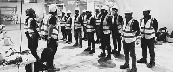 Safety meeting with construction workers in hard hats